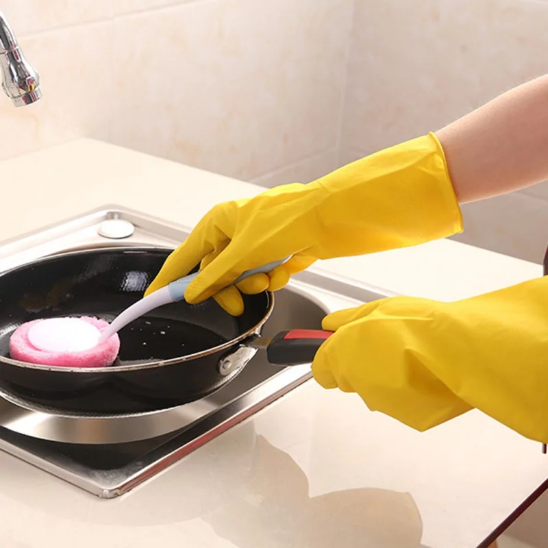 Crop faceless person in yellow latex protective gloves pouring cleaning agent from bottle to sponge in bathroom